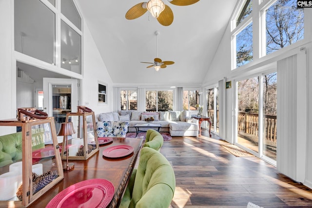 sunroom featuring lofted ceiling and a ceiling fan