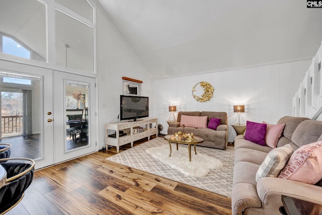 living room with lofted ceiling, french doors, and wood finished floors