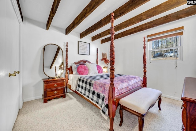 bedroom featuring beamed ceiling, carpet, and baseboards