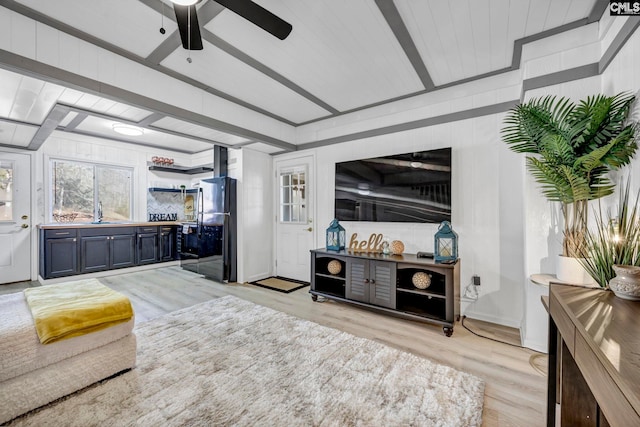 living room featuring light wood-type flooring and a ceiling fan