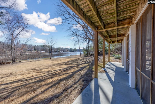 view of yard featuring a patio and a water view