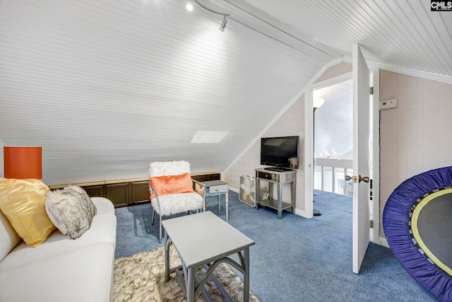 living area featuring lofted ceiling, dark colored carpet, ornamental molding, and rail lighting