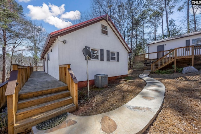 rear view of house featuring stairs, a wooden deck, and central air condition unit