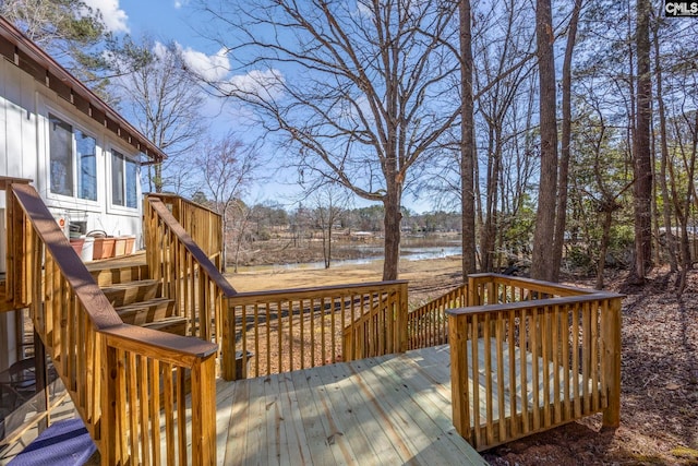 wooden deck featuring stairs and a water view