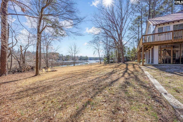 view of yard featuring a deck with water view