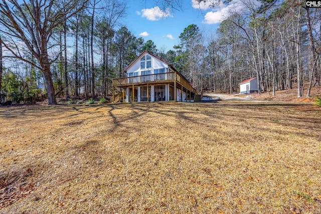 exterior space featuring a deck, a front yard, and stairway