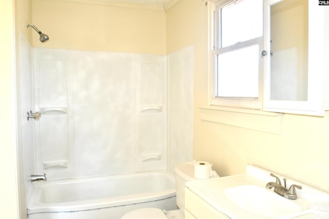 bathroom featuring tub / shower combination, crown molding, vanity, and toilet