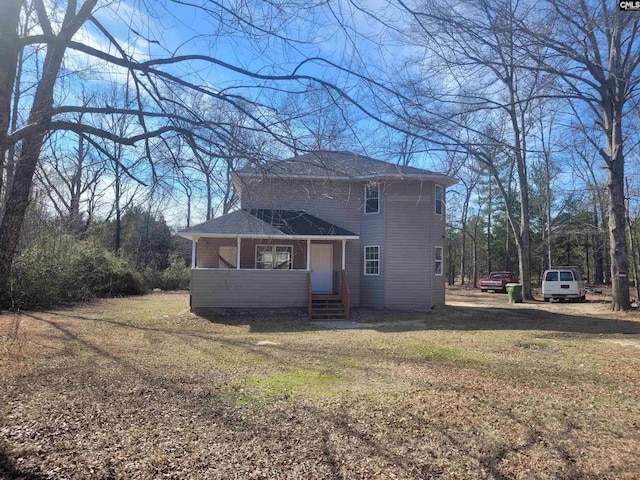 view of front of house with entry steps and a front lawn