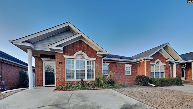 ranch-style house featuring brick siding