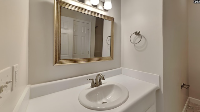 bathroom featuring vanity and baseboards