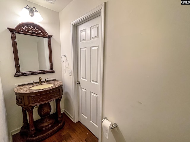 half bath featuring wood finished floors