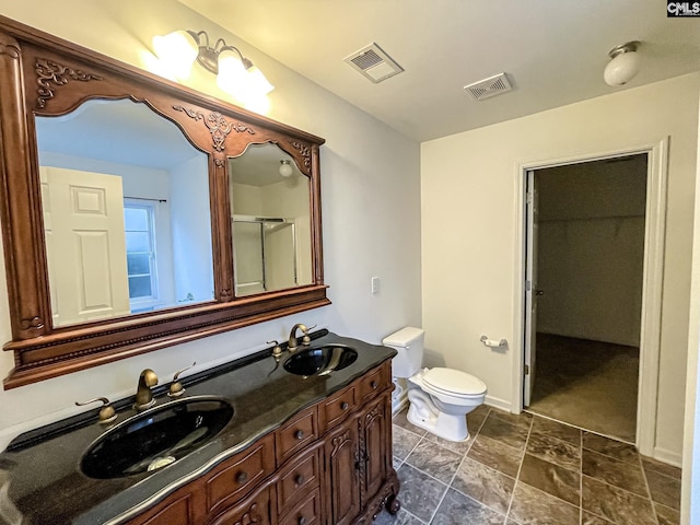 bathroom with double vanity, a sink, and visible vents