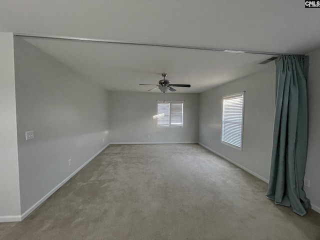 empty room with light carpet, baseboards, and a ceiling fan