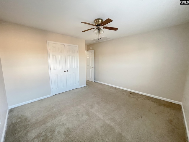 unfurnished bedroom featuring light carpet, a closet, and baseboards