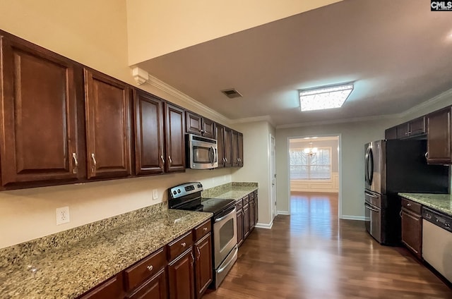 kitchen with stainless steel appliances, visible vents, crown molding, and light stone counters