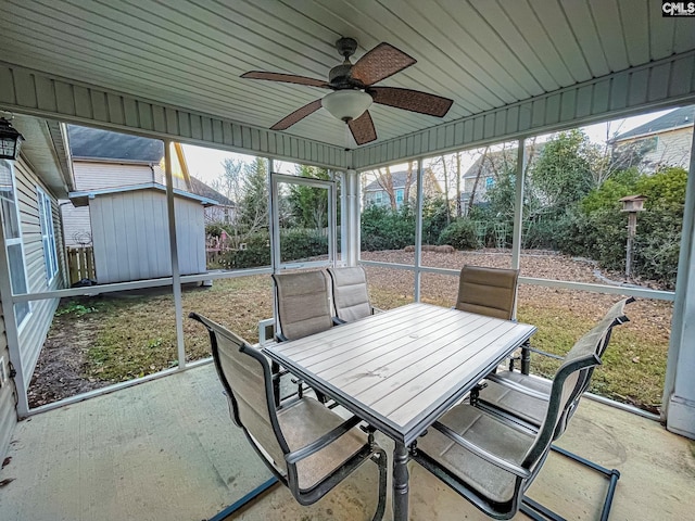 unfurnished sunroom featuring a ceiling fan