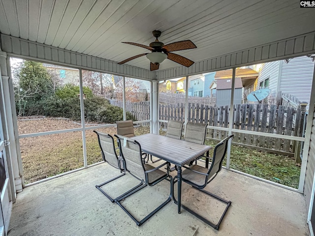 sunroom with plenty of natural light and a ceiling fan