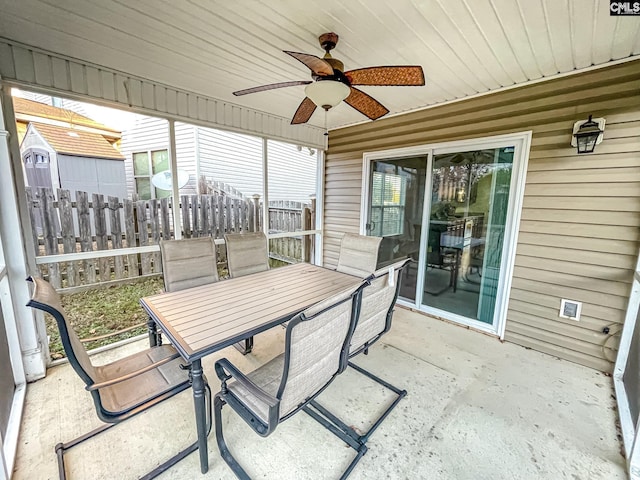 sunroom / solarium featuring a ceiling fan and wooden ceiling