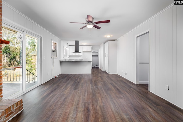 unfurnished living room with dark wood-type flooring, crown molding, and ceiling fan