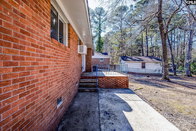 exterior space with brick siding, a patio area, and fence