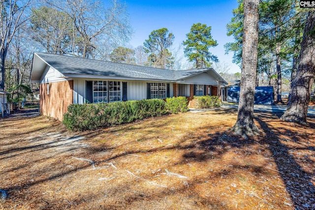 single story home featuring brick siding