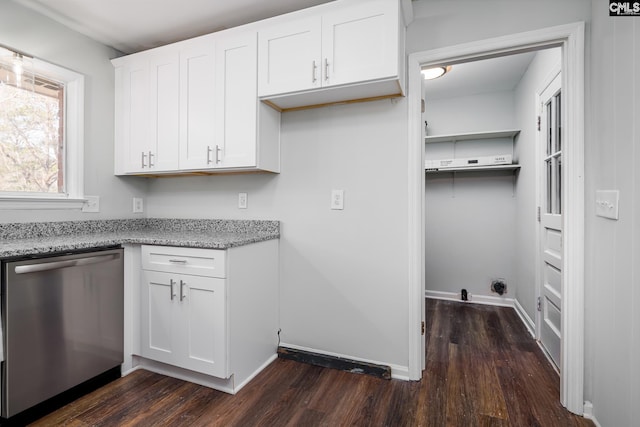 washroom with dark wood-style flooring and baseboards