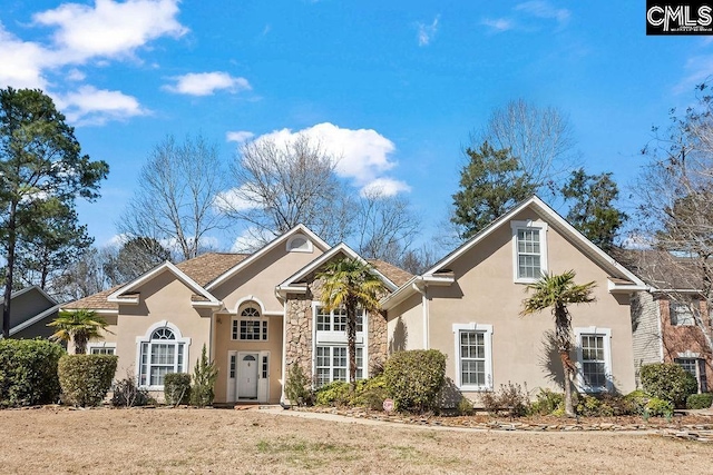 traditional-style home featuring stone siding and stucco siding