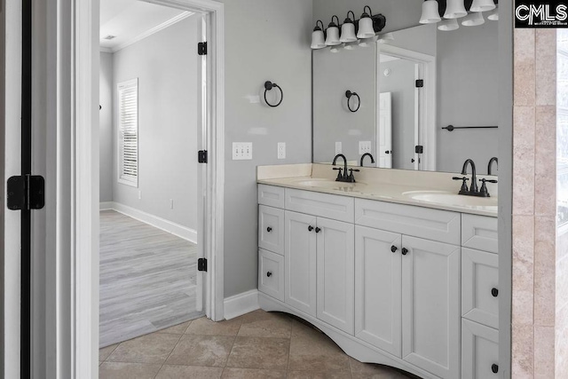 full bath featuring crown molding, tile patterned floors, a sink, and double vanity