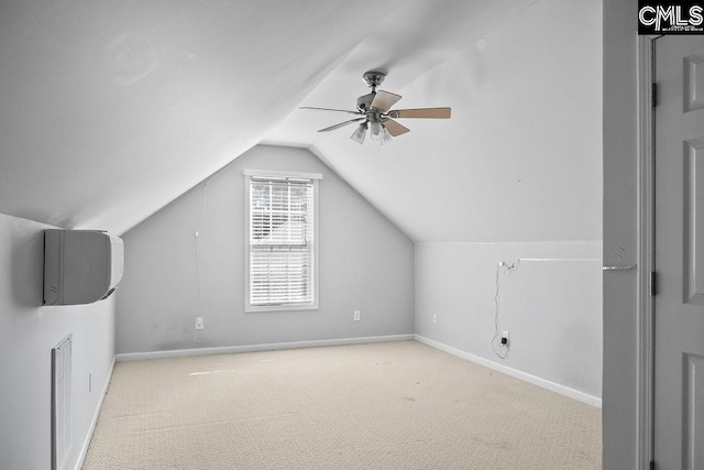 bonus room with light carpet, baseboards, visible vents, a ceiling fan, and vaulted ceiling