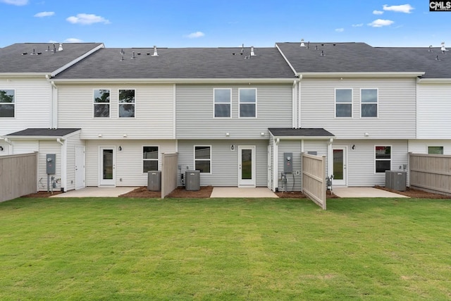 rear view of house with a patio area, central AC unit, and a lawn