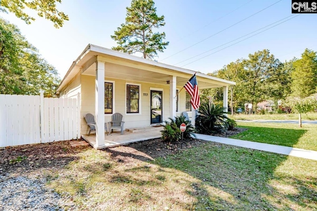 bungalow-style home featuring a porch, a front yard, and fence