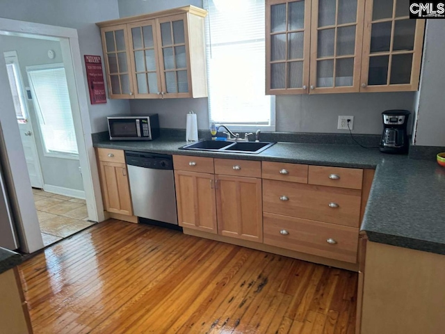 kitchen with glass insert cabinets, dark countertops, and appliances with stainless steel finishes