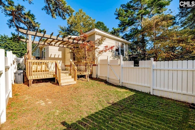 exterior space with a yard, a fenced backyard, a wooden deck, and a pergola