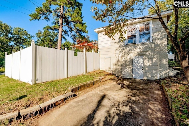 view of side of home with fence