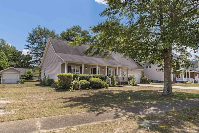 view of front of home with a garage, a front lawn, a porch, and fence