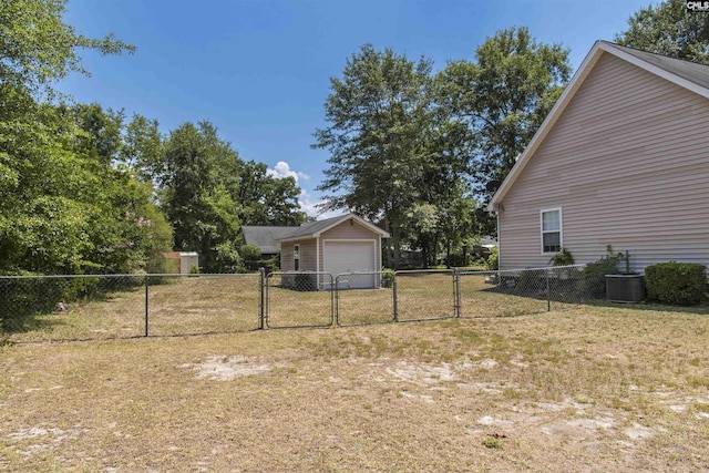 view of yard featuring cooling unit, a gate, fence, and an outdoor structure