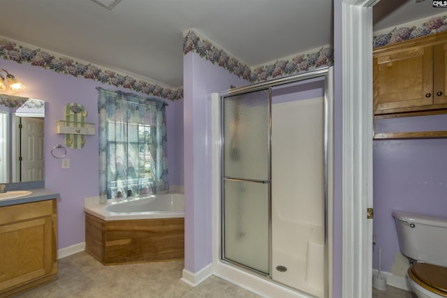 bathroom with toilet, a shower stall, vanity, baseboards, and a bath