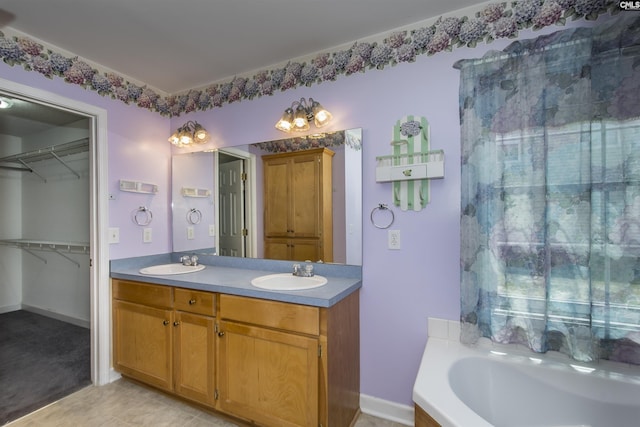 bathroom with baseboards, a sink, a bath, and double vanity