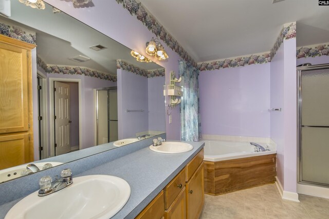 bathroom featuring a stall shower, a sink, visible vents, and tile patterned floors