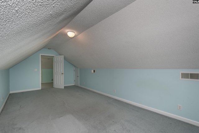 additional living space with carpet, visible vents, and baseboards