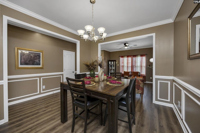 dining room featuring dark wood-type flooring, a wainscoted wall, crown molding, and a decorative wall