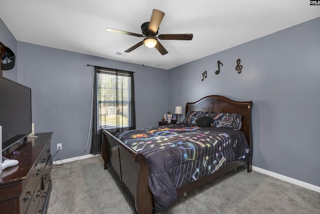 bedroom featuring light colored carpet, ceiling fan, visible vents, and baseboards