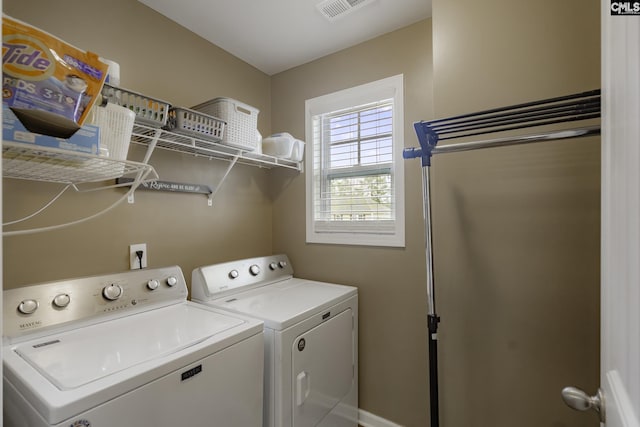 washroom with washing machine and dryer, laundry area, and visible vents