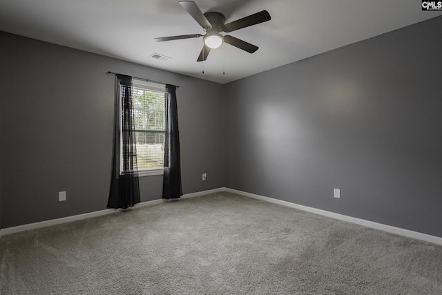 unfurnished room with ceiling fan, carpet flooring, visible vents, and baseboards