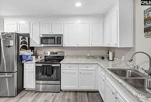 kitchen with appliances with stainless steel finishes and white cabinets