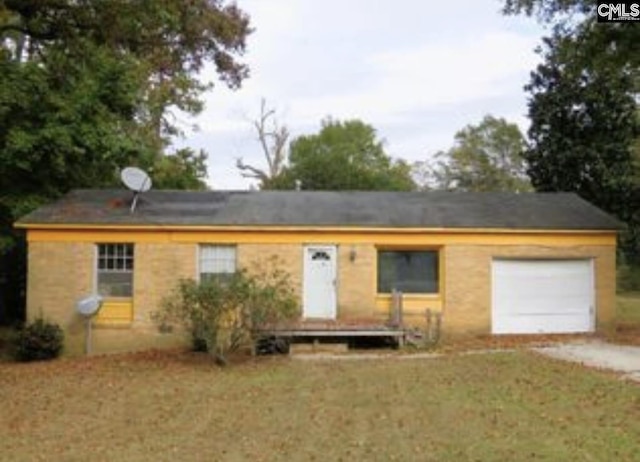 ranch-style house with a front lawn, driveway, and an attached garage