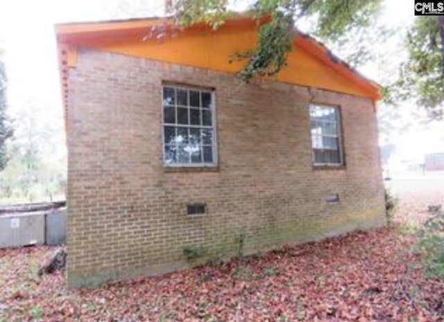 view of property exterior with brick siding