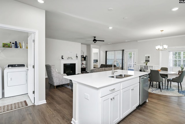 kitchen featuring washer / dryer, a sink, open floor plan, dishwasher, and a center island with sink