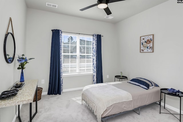 bedroom featuring light carpet, a ceiling fan, visible vents, and baseboards