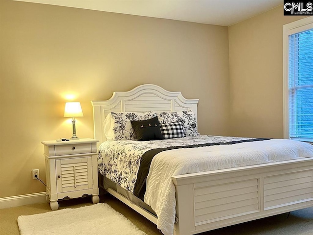 bedroom featuring carpet floors and baseboards